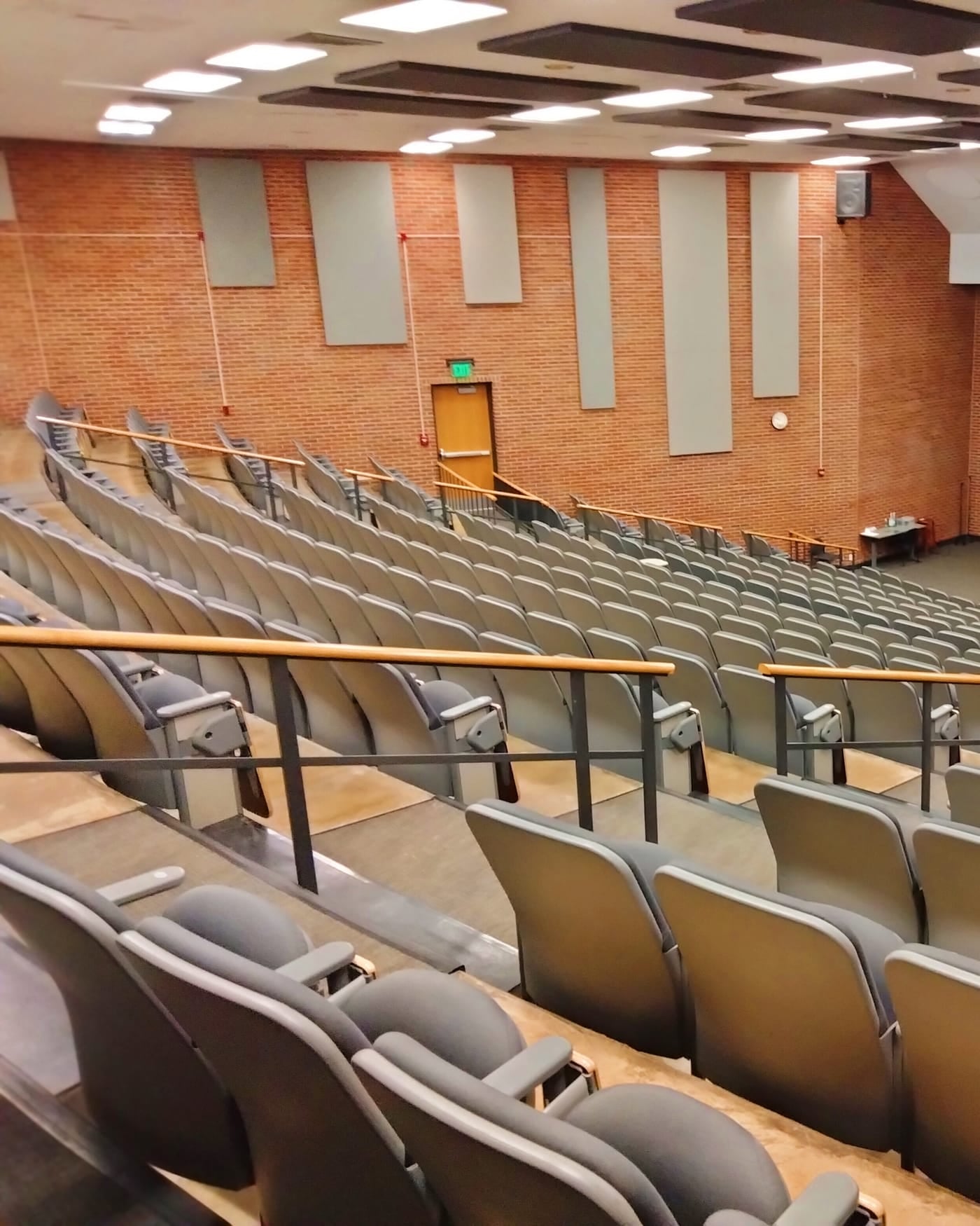 Rows of empty tiered seats in a university lecture hall