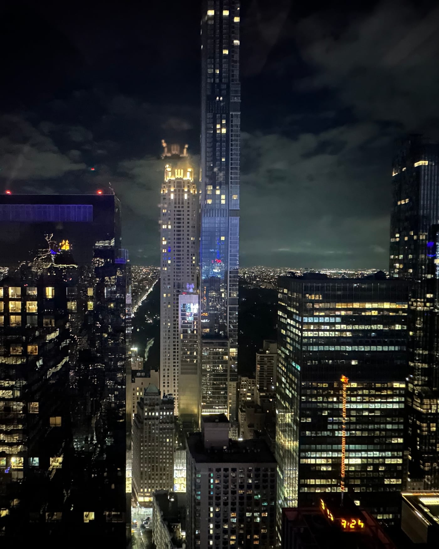 Night view of Midtown Manhattan skyscrapers with office windows lit