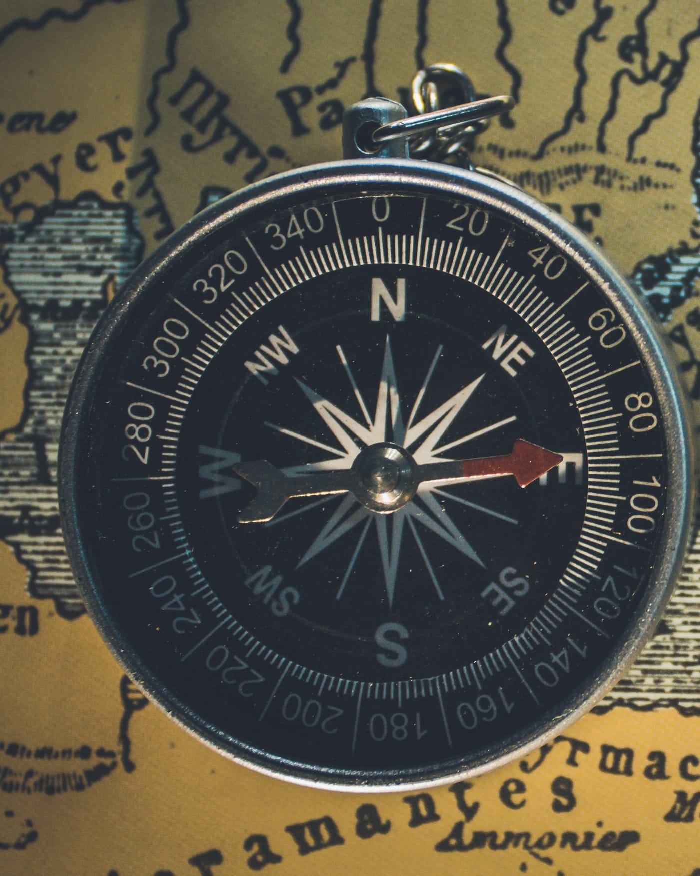 Brass compass lying on an antique map of the eastern Mediterranean